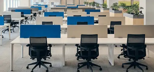 Modern open-plan office space featuring clean workstations, ergonomic chairs, and sanitized carpets provided by professional office cleaning services in Columbus, OH.